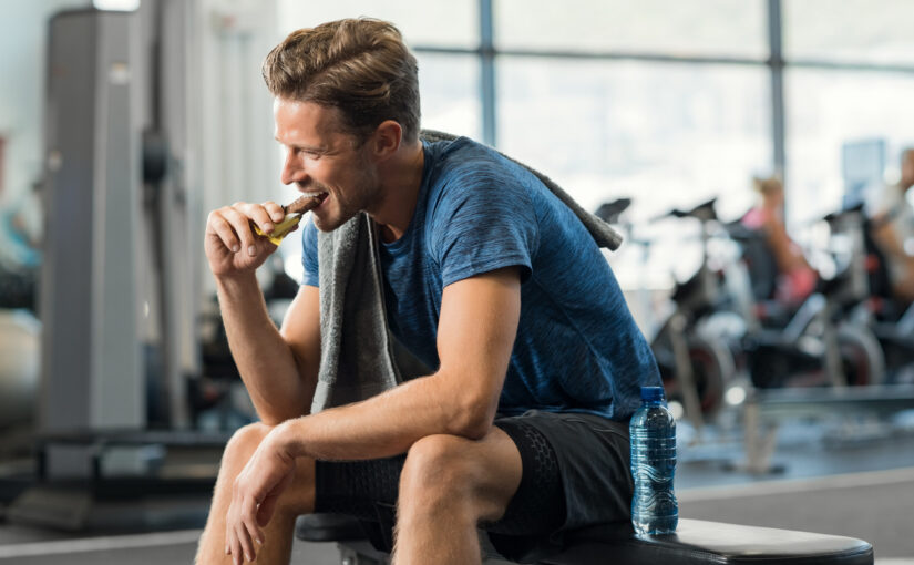 man enjoys chocolate health benefits after working out at the gym