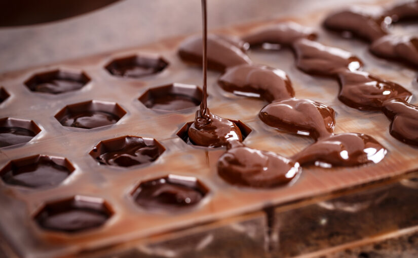 melted chocolate drizzled into chocolate molds