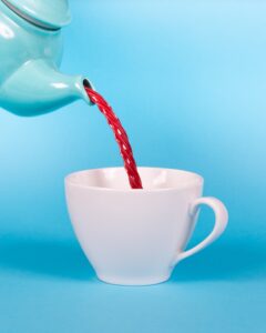 tea pot "pouring" licorice into a tea cup