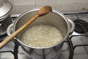 simple syrup being made in a pan on the stove