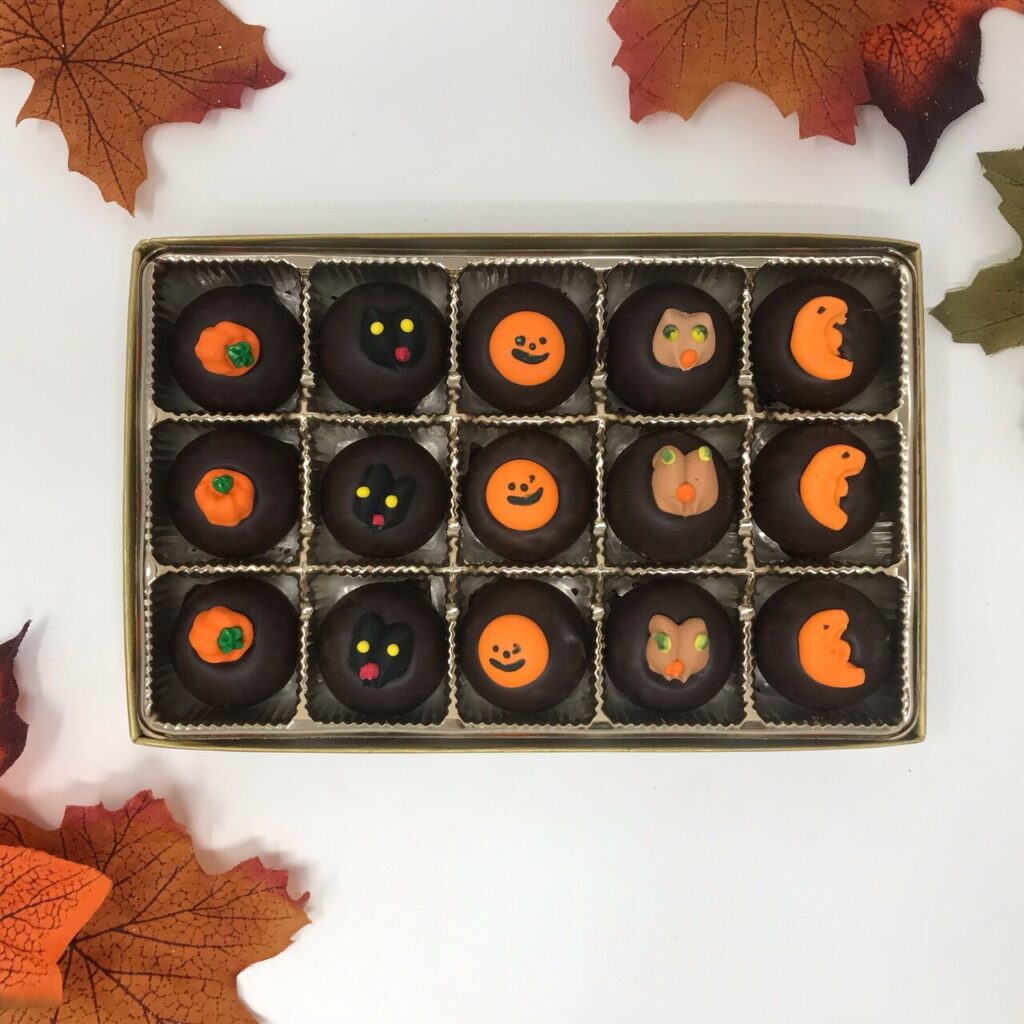 box of chocolate mints decorated with pumpkins, black cats, and other Halloween designs