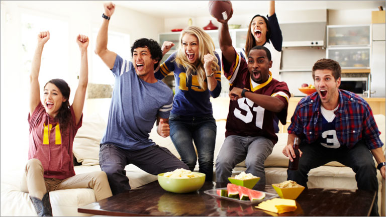 friends cheering at a Super Bowl party