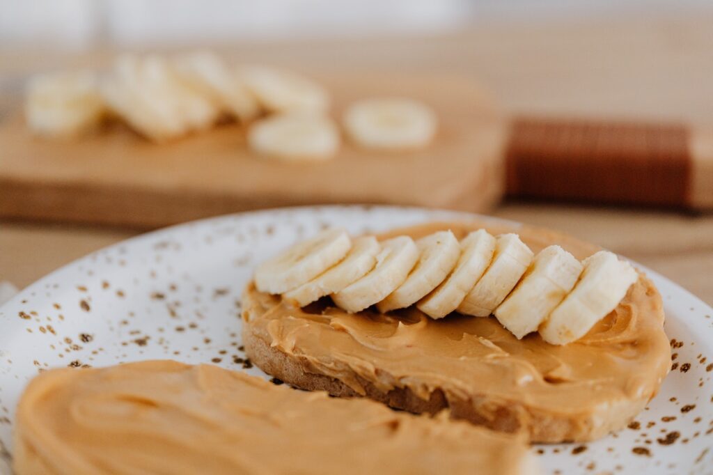 close-up of plate with peanut butter bread and banana slices