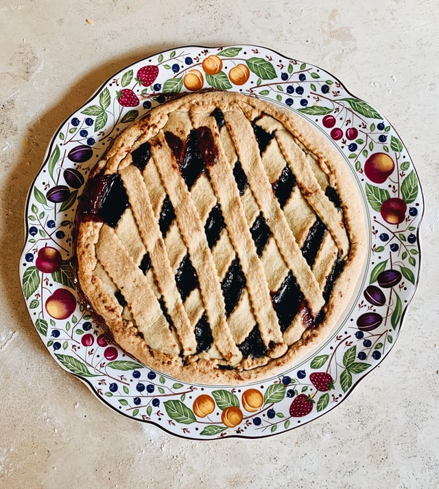 homemade lattice crust pie on a fruit design serving platter